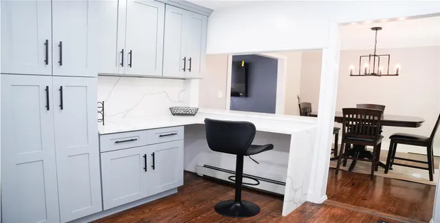 a view of a kitchen with dining area a sink and wooden floor