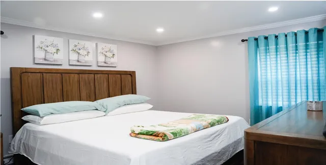 a bedroom with a bed and a window