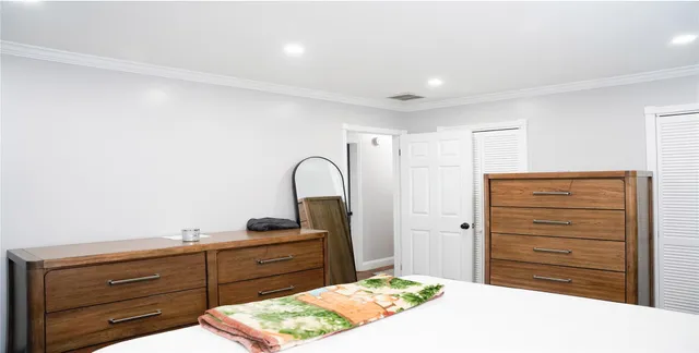 a bedroom with a bed and a dresser