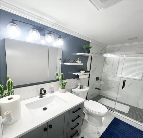 a bathroom with a sink toilet and shower
