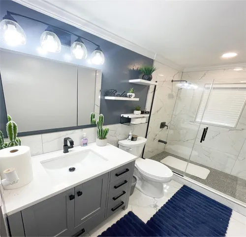 a bathroom with a sink mirror and toilet