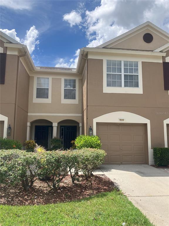 a front view of a house with a yard and garage
