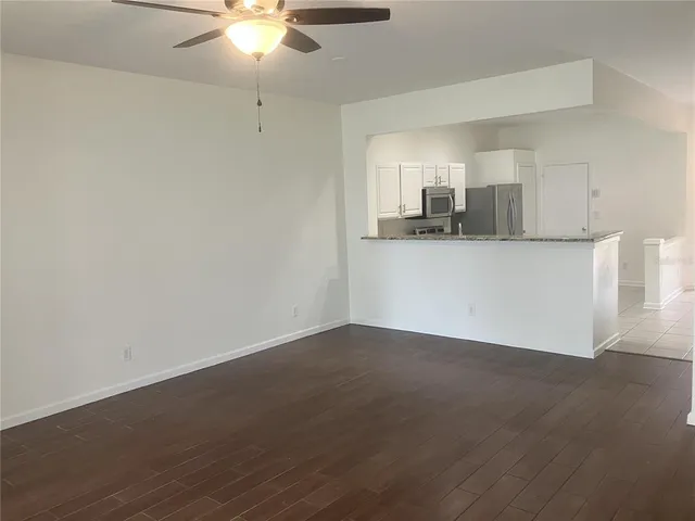 a view of a kitchen with a sink and a chandelier fan