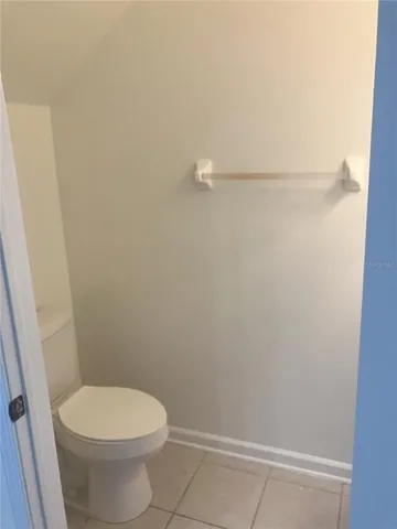 a white toilet sitting next to a shower