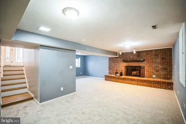 an empty room with fireplace and windows