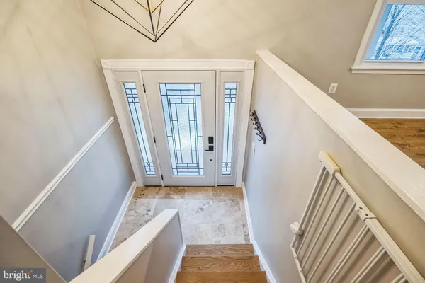 a view of entryway with furniture and front door