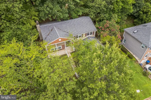 an aerial view of a house with swimming pool and garden