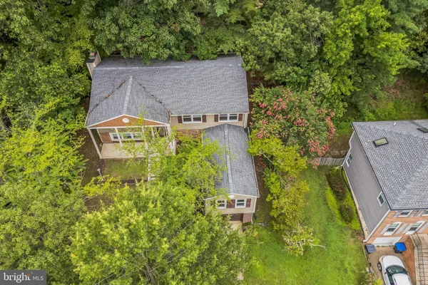 an aerial view of a house with a yard swimming pool and outdoor seating