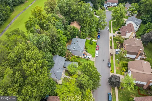 an aerial view of a house with a yard and outdoor seating