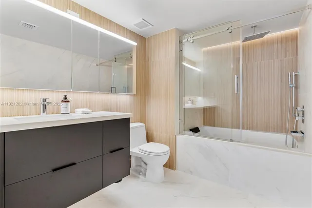 a bathroom with a sink toilet and shower