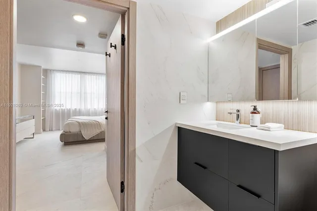 a en suite bathroom with a sink double vanity and a mirror
