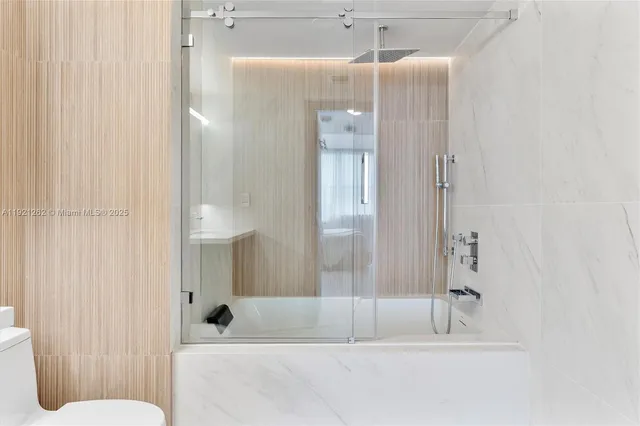 a bathroom with a bathtub and a shower