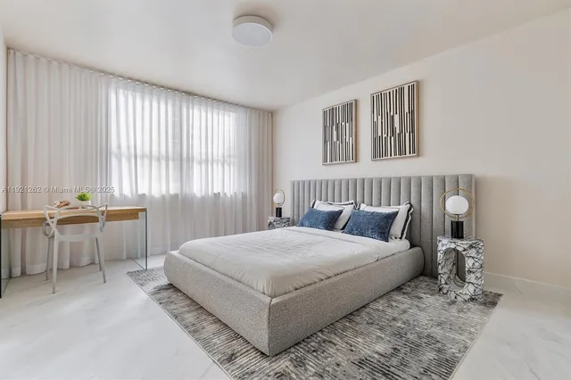 a living room with a bed furniture and a window