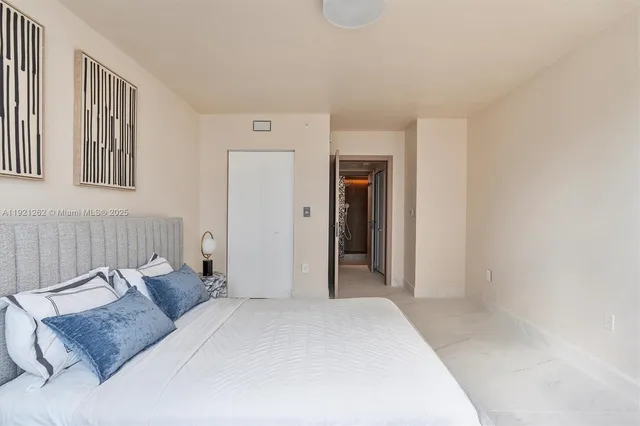 a bedroom with a bed and a couch