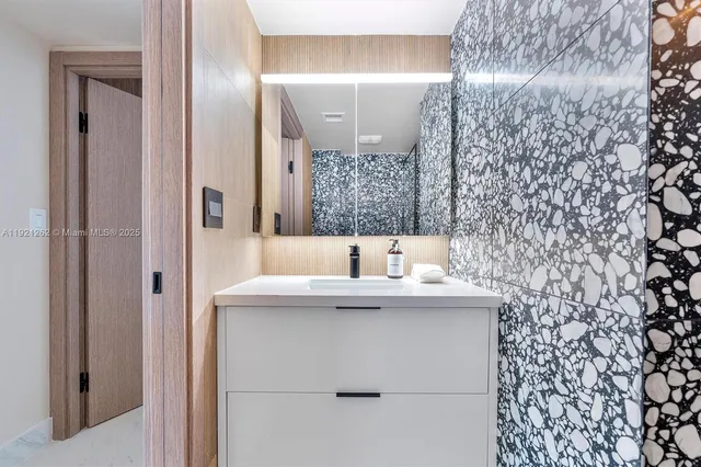 a bathroom with a sink and mirror