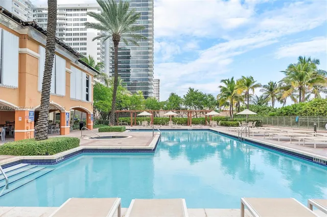 a view of swimming pool with outdoor seating and plants