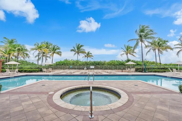 a view of swimming pool with a lounge chair