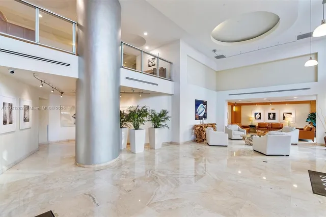a view of a livingroom with furniture and a potted plant