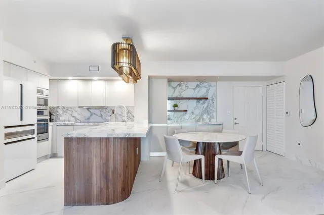 a kitchen with kitchen island a stove a table and chairs
