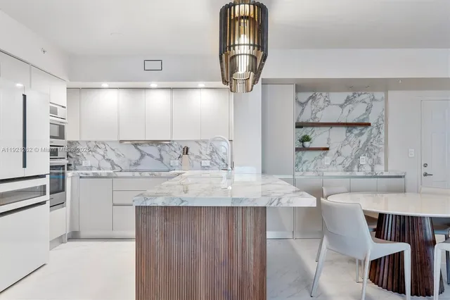 a view of kitchen island wooden cabinets and living room
