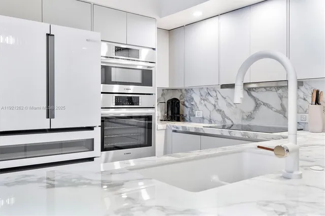 a kitchen with granite countertop a refrigerator and a stove