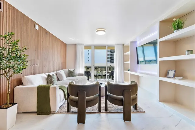 a living room with furniture and a potted plant