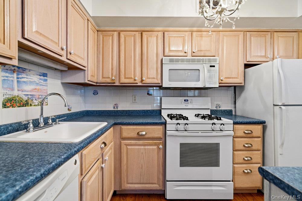 55 Rocky Point Yaphank Road, Unit 38 Rocky Point, NY 11764 - Photo 14 of 25 a kitchen with granite countertop cabinets stainless steel appliances and a sink