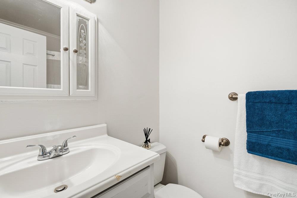 55 Rocky Point Yaphank Road, Unit 38 Rocky Point, NY 11764 - Photo 19 of 25 a bathroom with a sink a toilet and shower