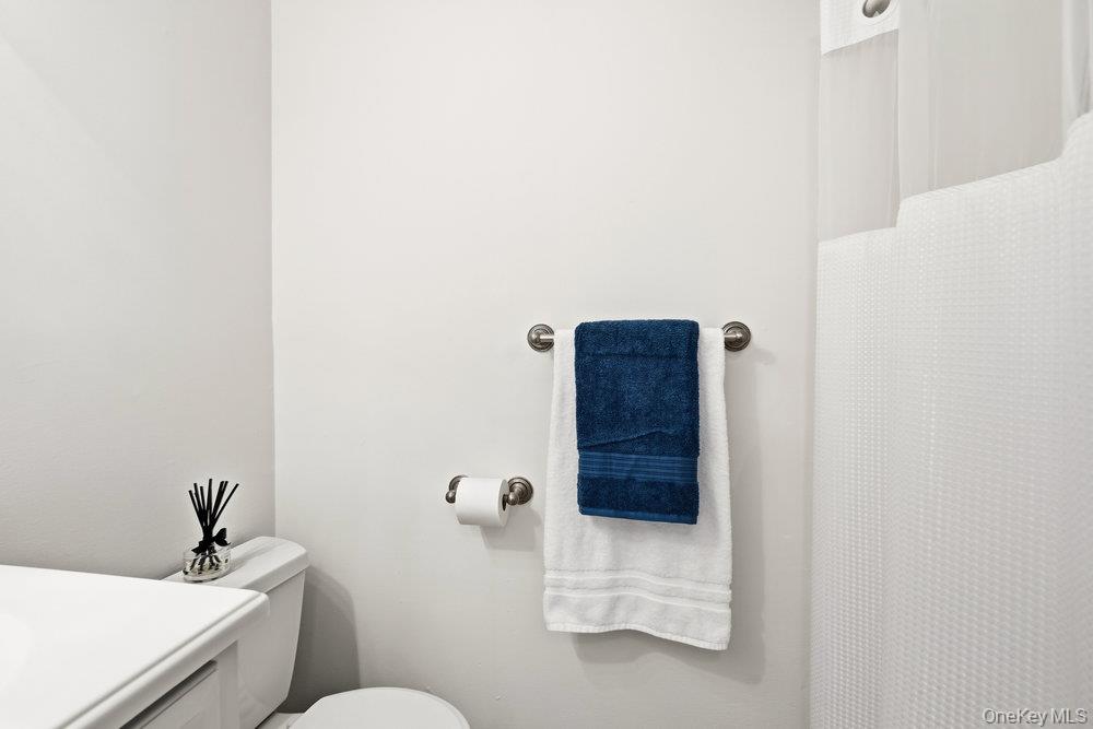 55 Rocky Point Yaphank Road, Unit 38 Rocky Point, NY 11764 - Photo 20 of 25 a bathroom with a sink and toilet