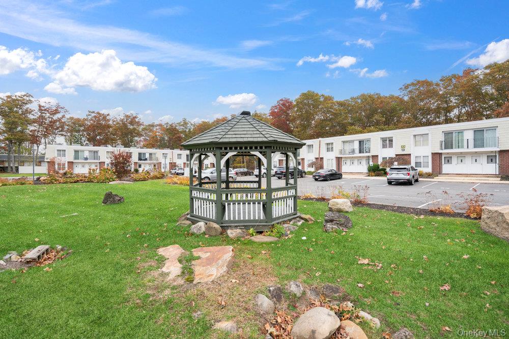 55 Rocky Point Yaphank Road, Unit 38 Rocky Point, NY 11764 - Photo 24 of 25 a garden view with a seating space