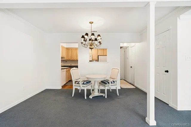 a dining room with furniture and chandelier