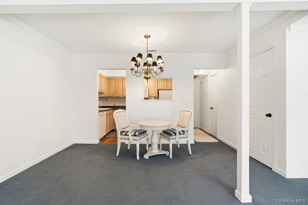 55 Rocky Point Yaphank Road, Unit 38 Rocky Point, NY 11764 - Photo 8 of 25 a dining room with furniture and chandelier