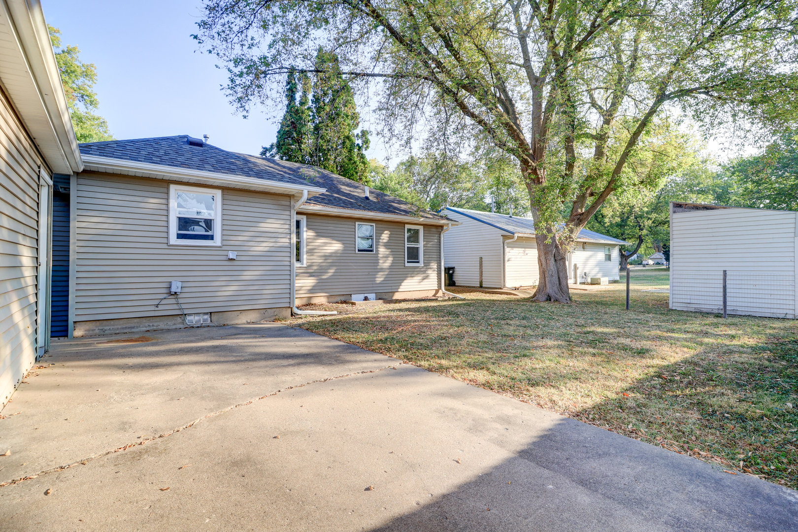 1013 West 8th Street Sterling, IL 61081 - Photo 19 of 22 a view of a yard in front of a house with large tree