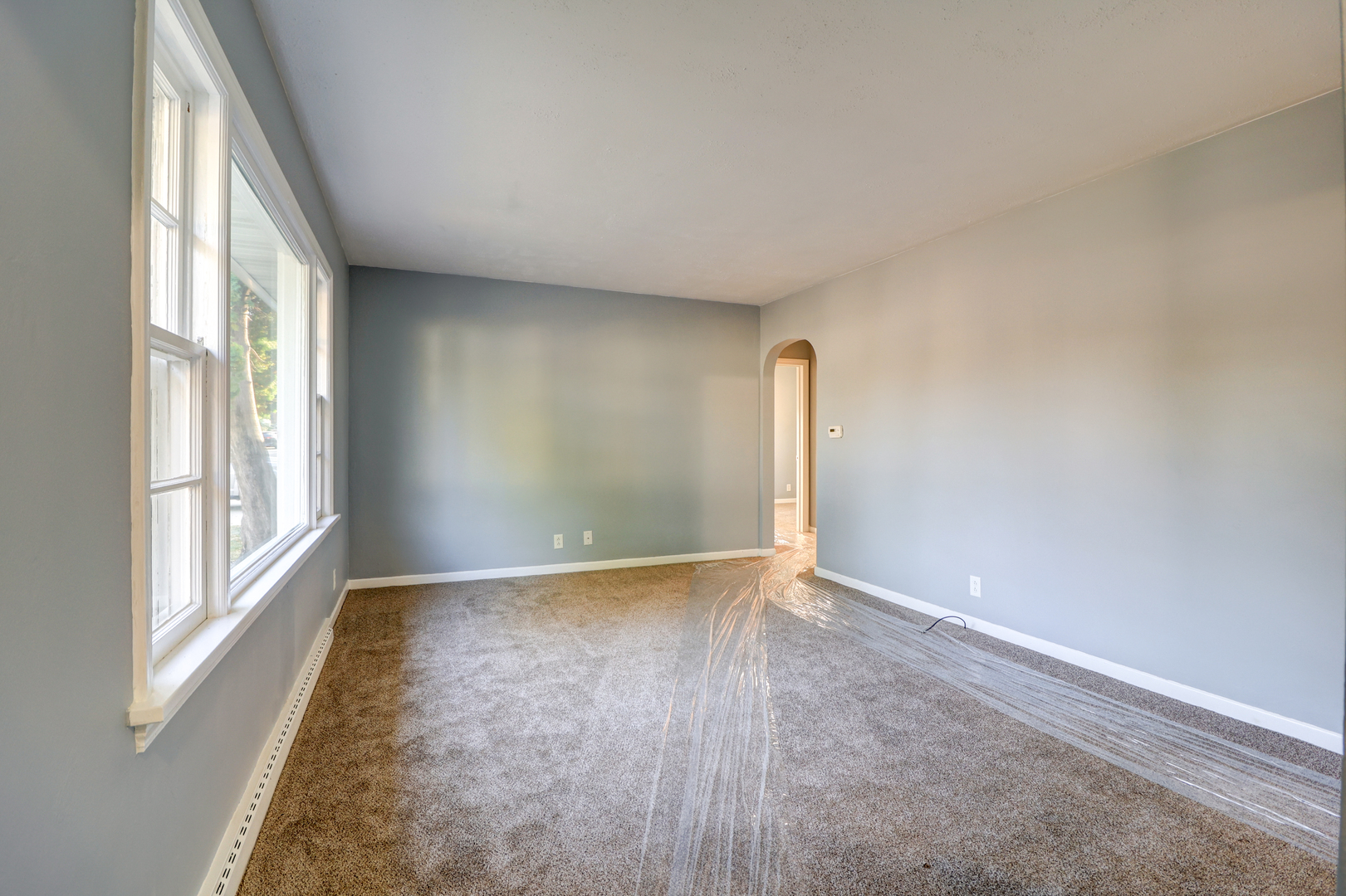 1013 West 8th Street Sterling, IL 61081 - Photo 4 of 22 an empty room with wooden floor and windows