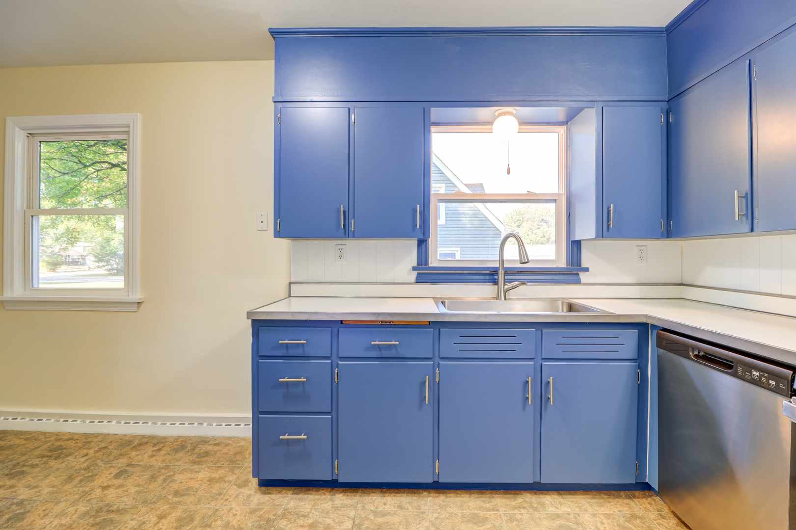 1013 West 8th Street Sterling, IL 61081 - Photo 8 of 22 a kitchen with a sink cabinets and window