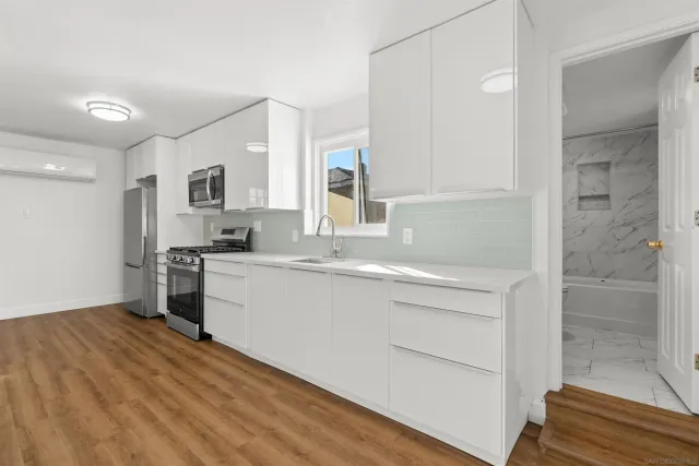 a view of a kitchen with a stove cabinets and wooden floor