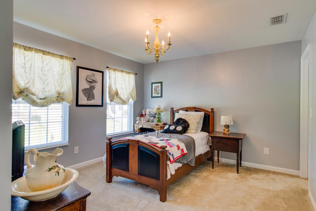4029 Williford Way Spring Hill, TN 37174 - Photo 15 of 22 a bedroom with a bed and a chandelier