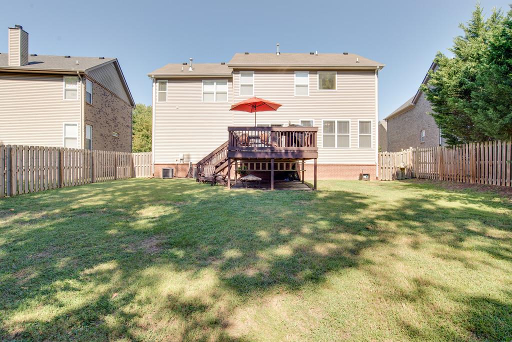 4029 Williford Way Spring Hill, TN 37174 - Photo 20 of 22 a view of a backyard with a small cabin and a chair