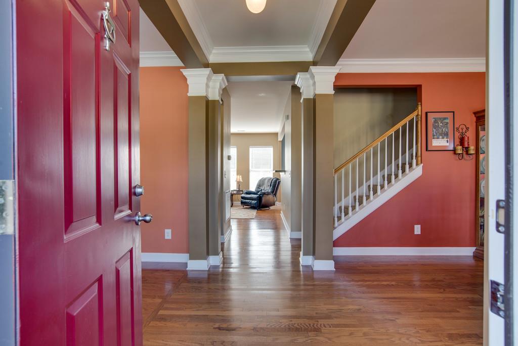 4029 Williford Way Spring Hill, TN 37174 - Photo 3 of 22 a view of a hallway with wooden floor and staircase
