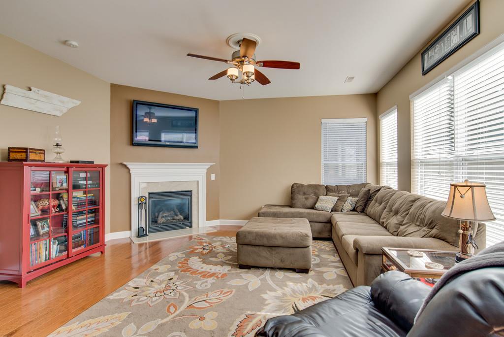 4029 Williford Way Spring Hill, TN 37174 - Photo 6 of 22 a living room with furniture a fireplace and a large window
