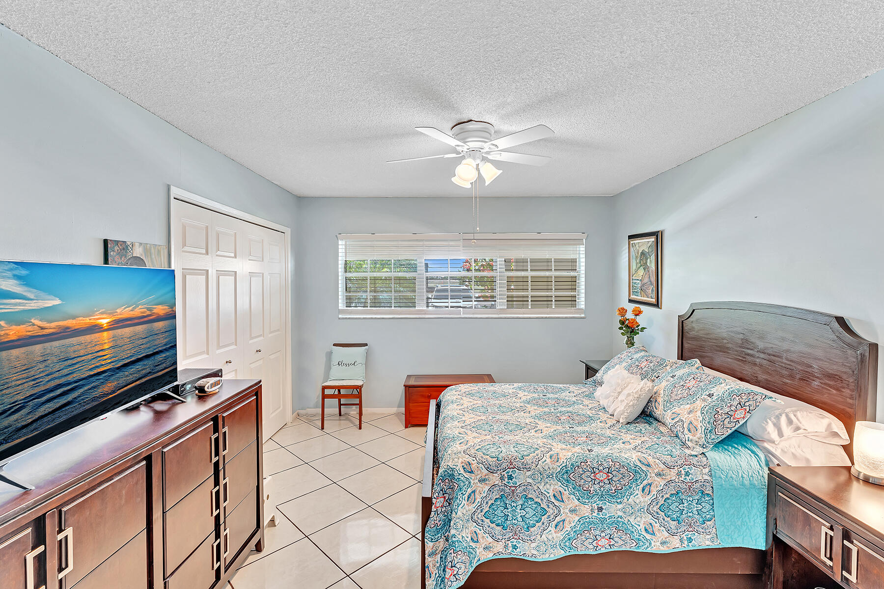 3091 North Course Drive, Unit 108 Pompano Beach, FL 33069 - Photo 15 of 42 a bedroom with a bed and a flat screen tv