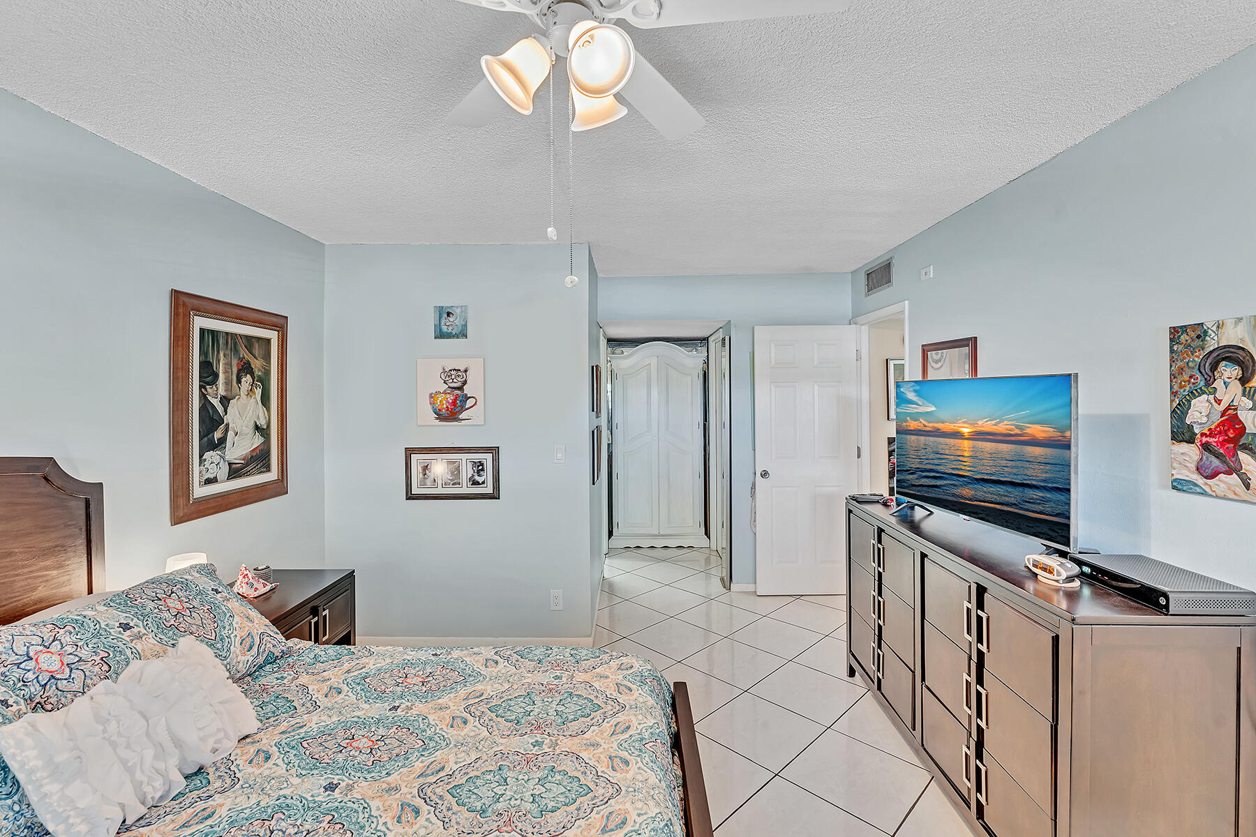 3091 North Course Drive, Unit 108 Pompano Beach, FL 33069 - Photo 17 of 42 a bedroom with a bed and a flat screen tv