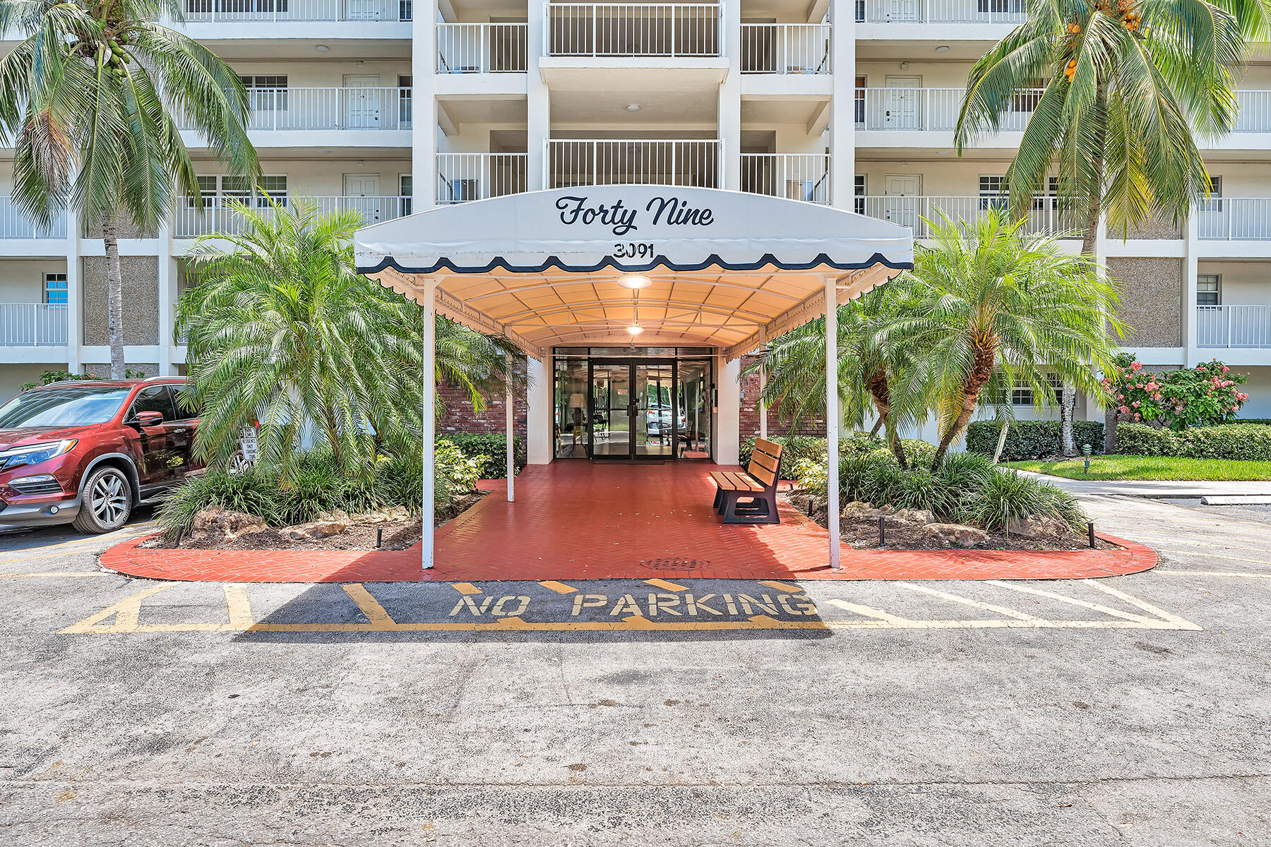 3091 North Course Drive, Unit 108 Pompano Beach, FL 33069 - Photo 2 of 42 front view of a building with a yard