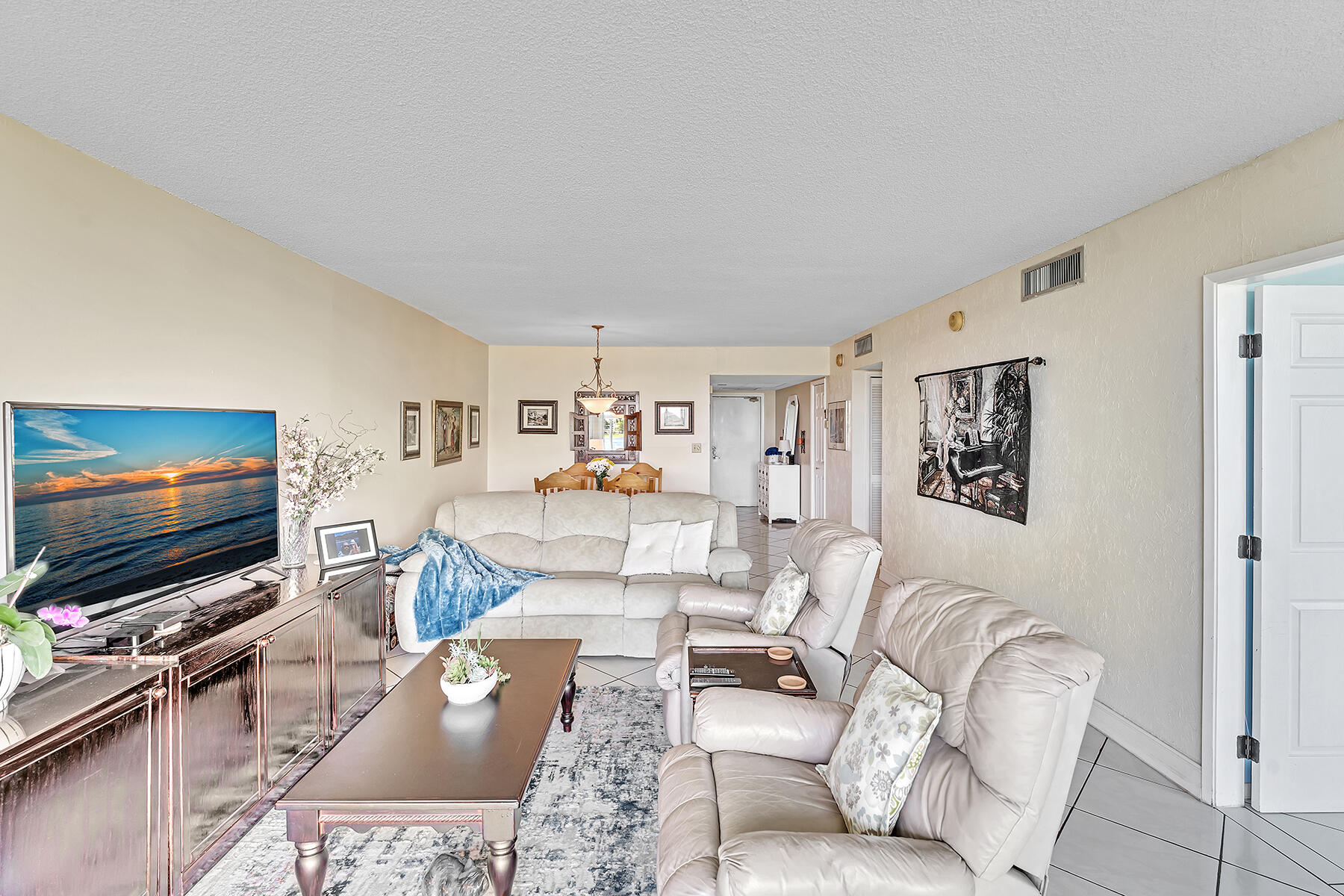 3091 North Course Drive, Unit 108 Pompano Beach, FL 33069 - Photo 21 of 42 a living room with furniture and a flat screen tv