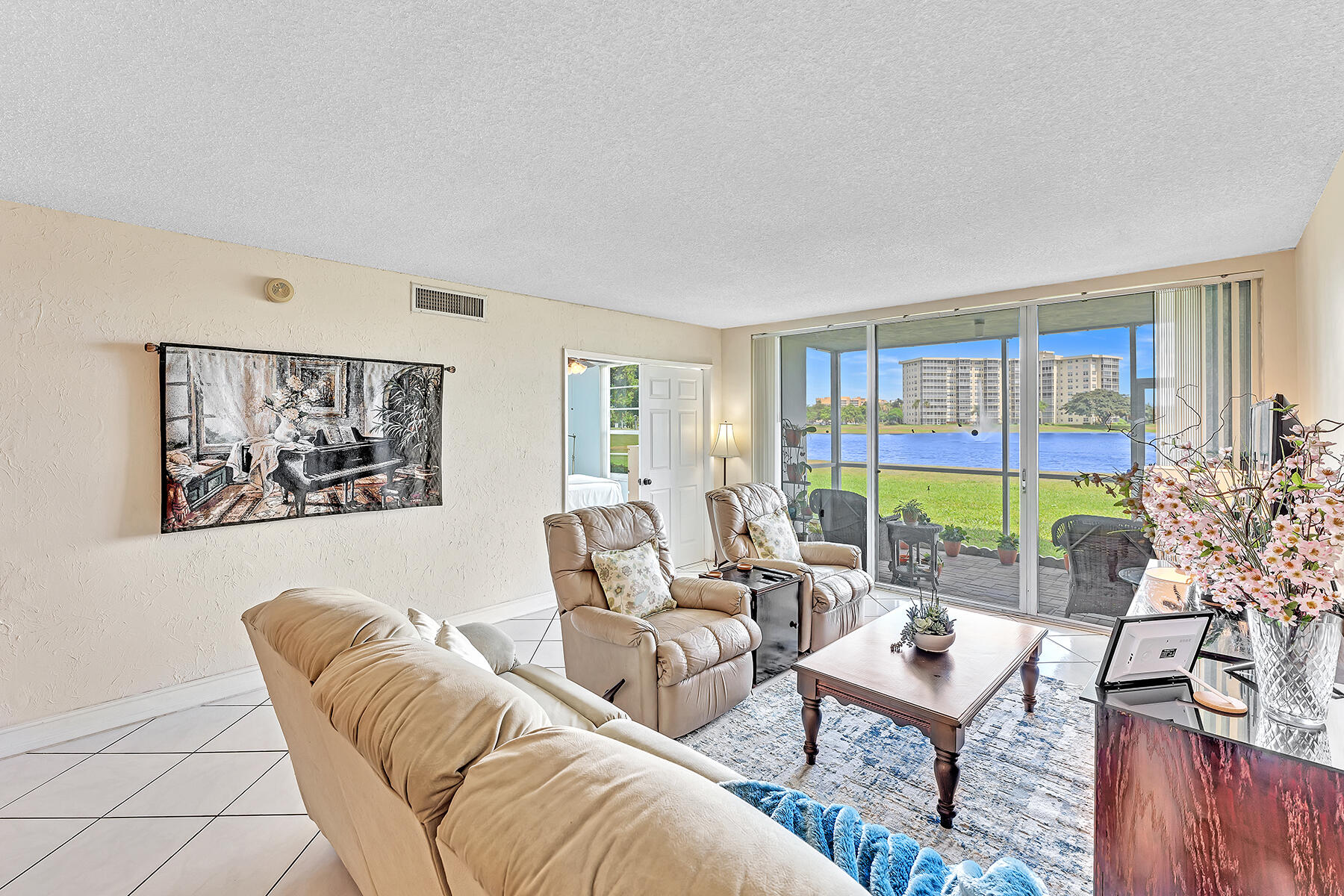 3091 North Course Drive, Unit 108 Pompano Beach, FL 33069 - Photo 22 of 42 a living room with furniture and a floor to ceiling window