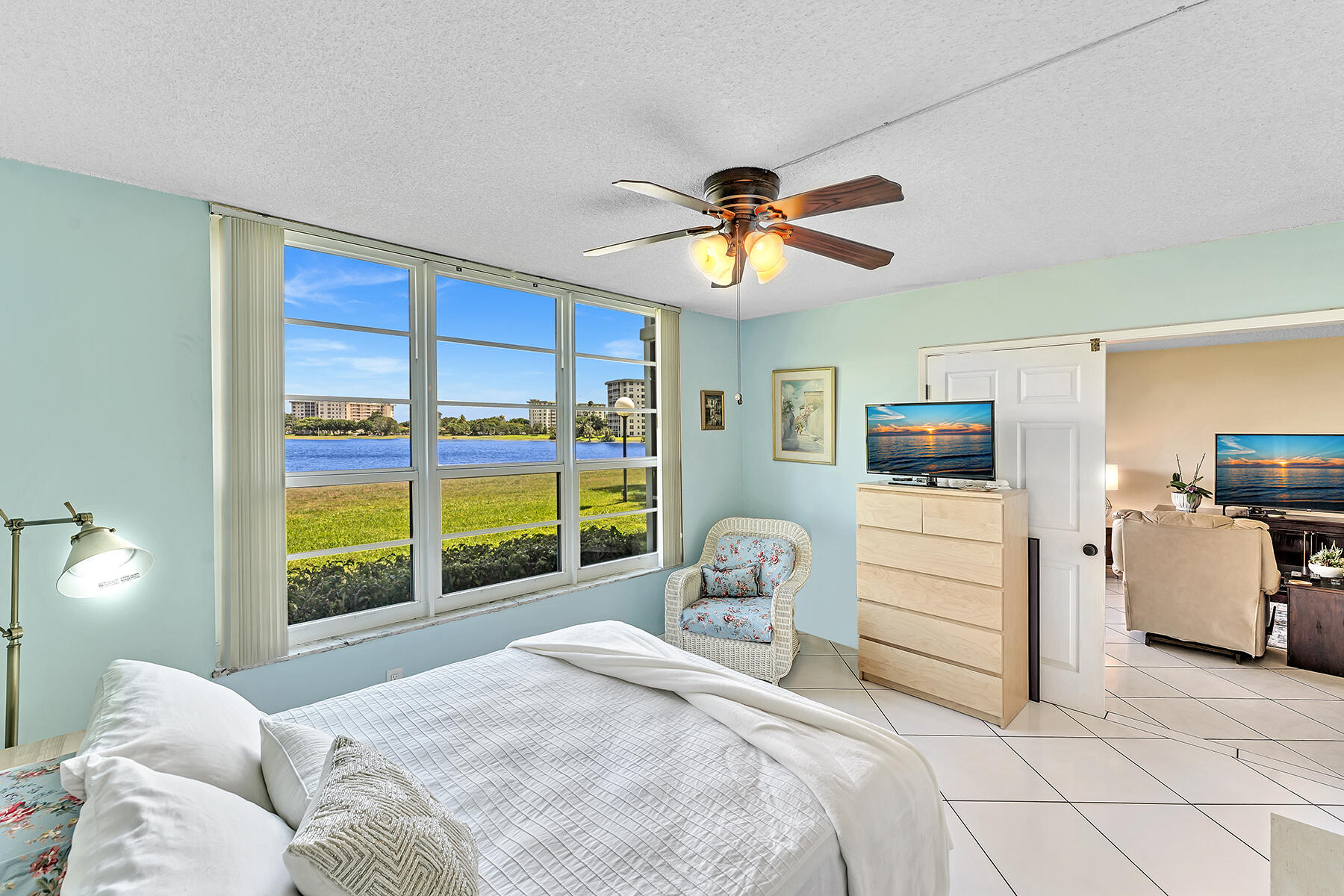 3091 North Course Drive, Unit 108 Pompano Beach, FL 33069 - Photo 26 of 42 a bedroom with a large bed and a window