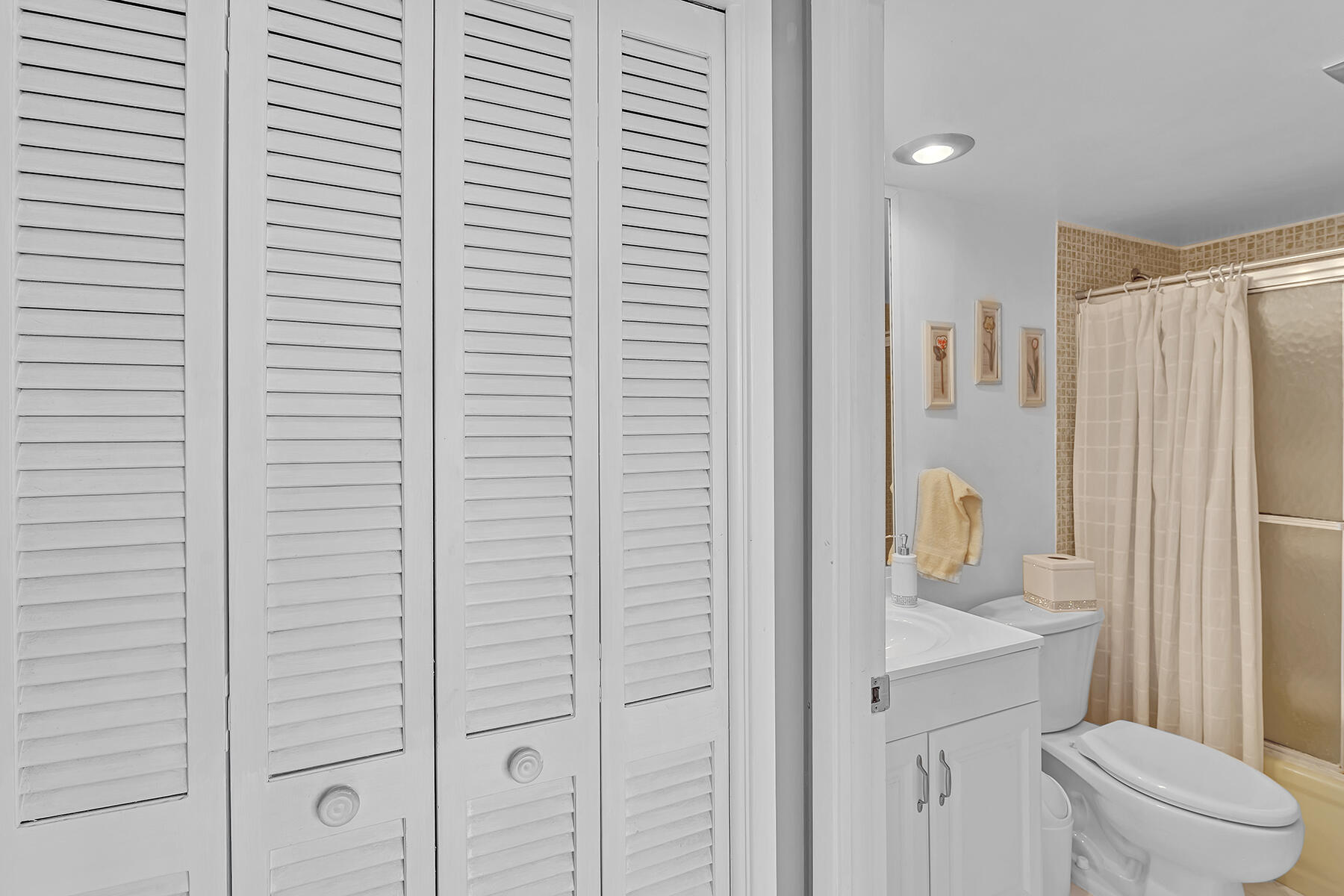 3091 North Course Drive, Unit 108 Pompano Beach, FL 33069 - Photo 28 of 42 a bathroom with a shower curtain and a toilet