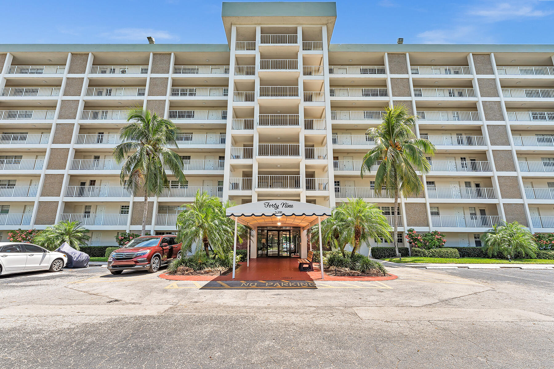 3091 North Course Drive, Unit 108 Pompano Beach, FL 33069 - Photo 3 of 42 a front view of a building with a street