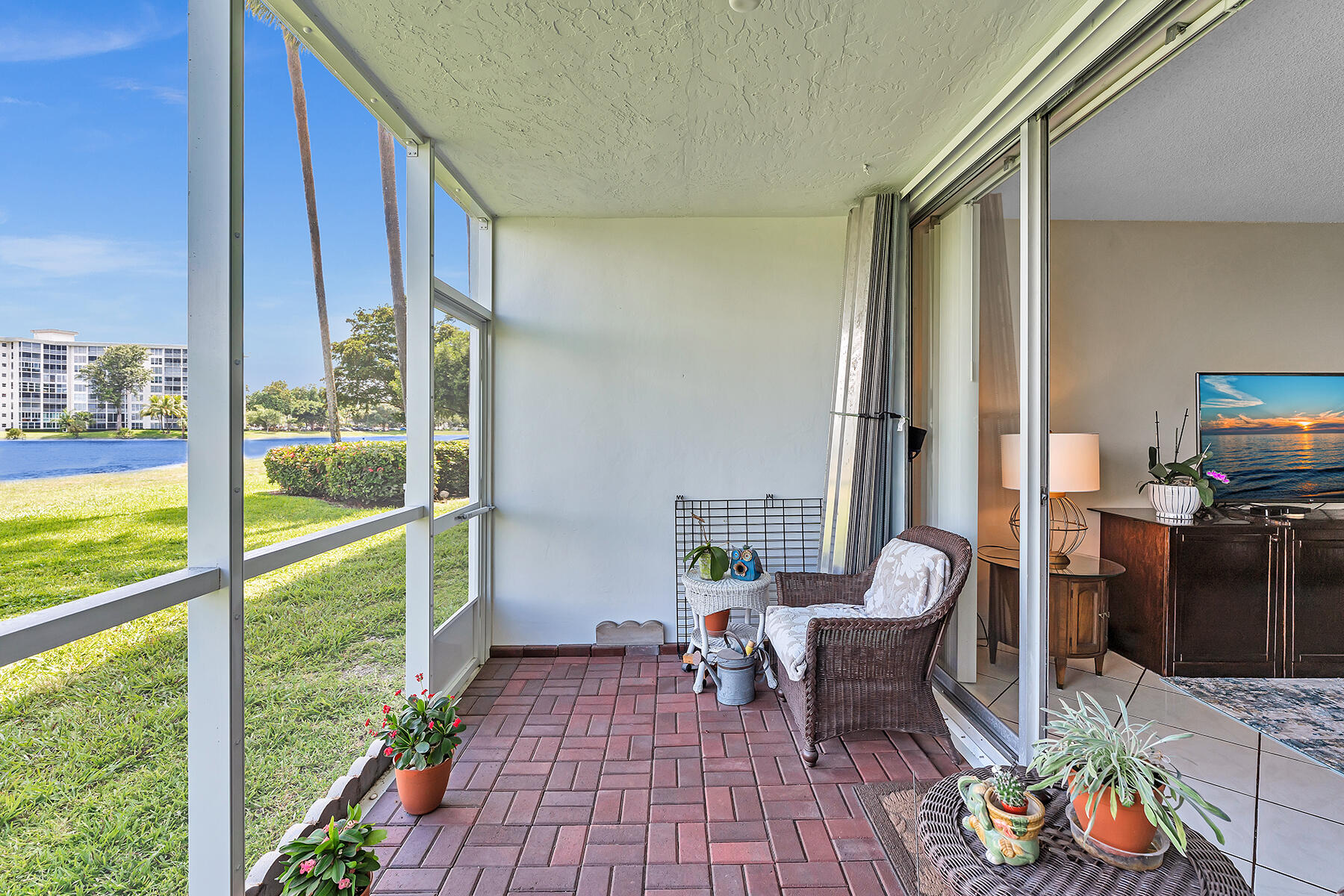 3091 North Course Drive, Unit 108 Pompano Beach, FL 33069 - Photo 32 of 42 a living room with furniture and a floor to ceiling window