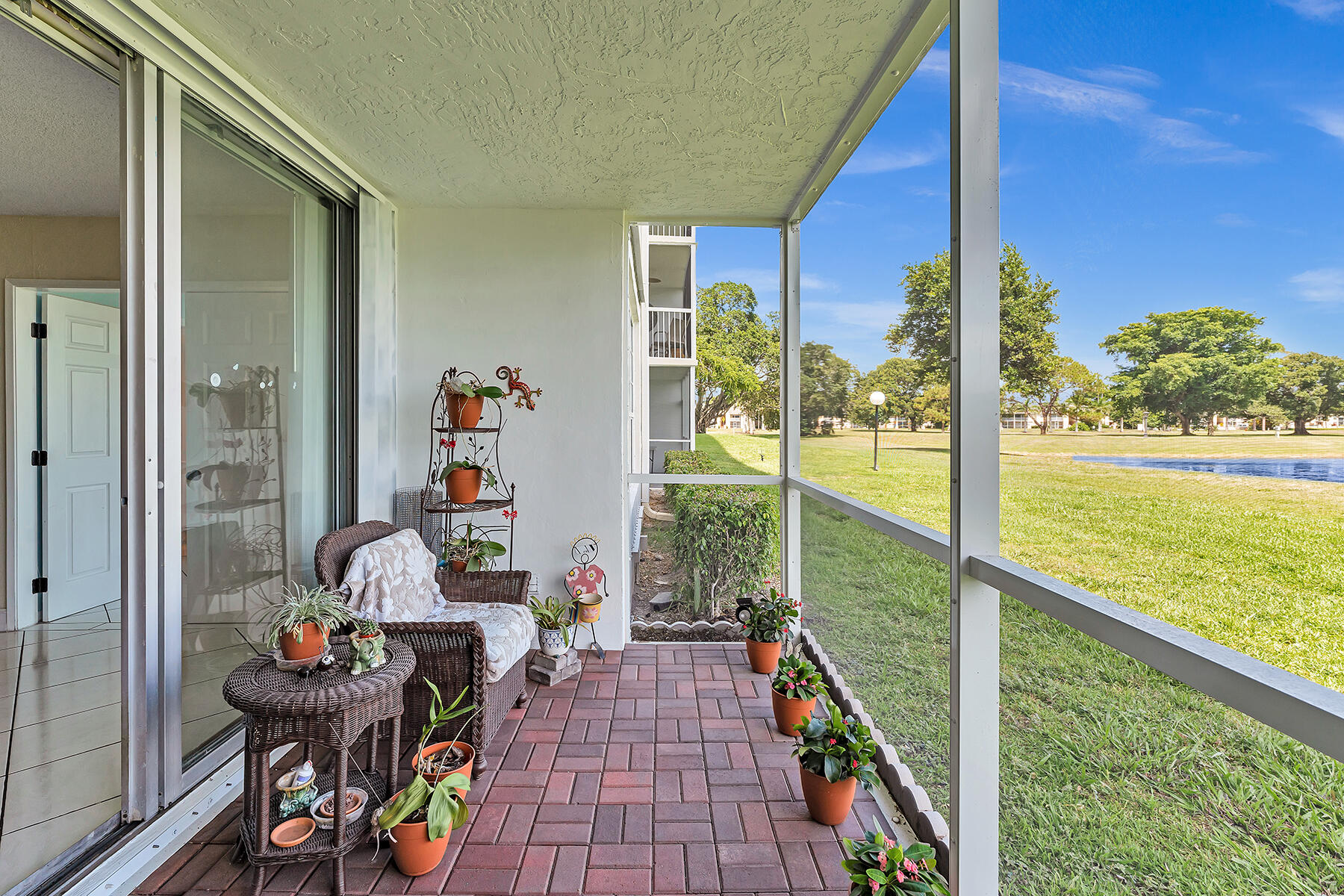 3091 North Course Drive, Unit 108 Pompano Beach, FL 33069 - Photo 33 of 42 a balcony with furniture and garden view